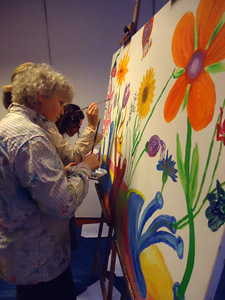 Workshop samen een groot schilderij maken tijdens bedrijfsfeest op lokatie voor op het bedrijf